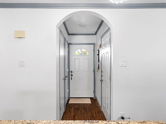 Entrance, coat closet and entry to garage