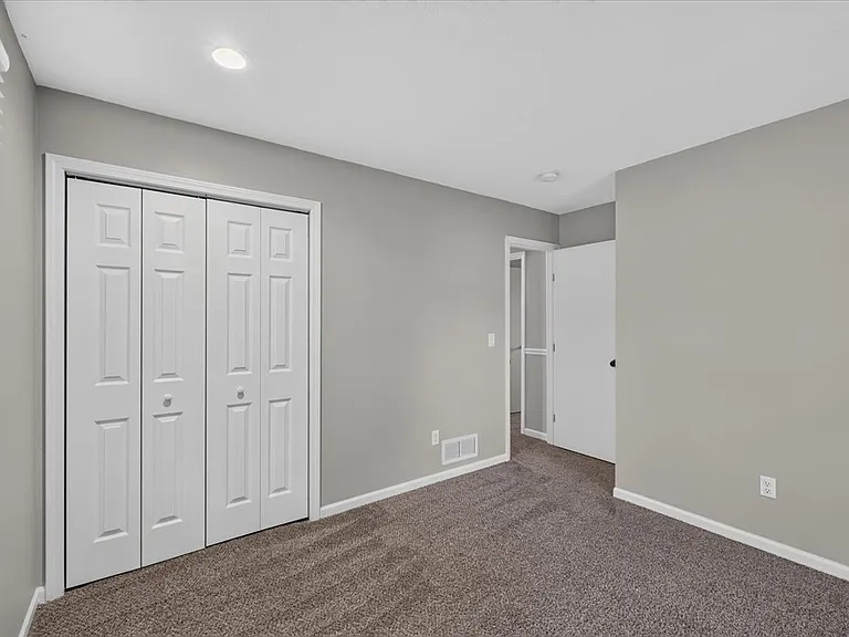 Primary bedroom with double closet.