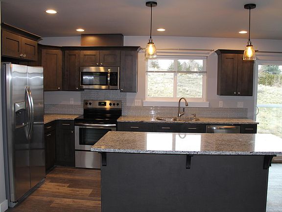 Open concept kitchen. Stainless steel appliance and granite counter tops