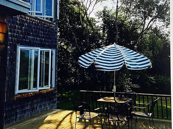 Deck view east toward trees and water