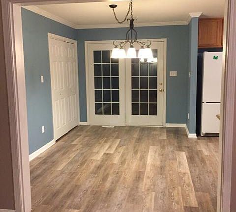 Large dining room, with laundry and deck access. Updated floors and chandelier.