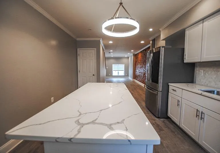 Walk in to an open first level; head to the back of the house to find the upgraded kitchen