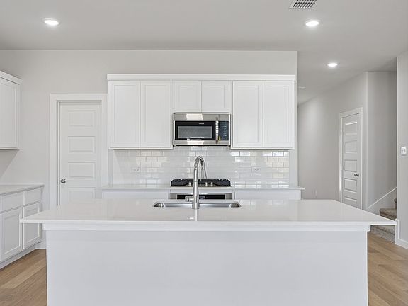 Kitchen in the Masters home plan by Trophy Signature Homes - REPRESENTATIVE PHOTO