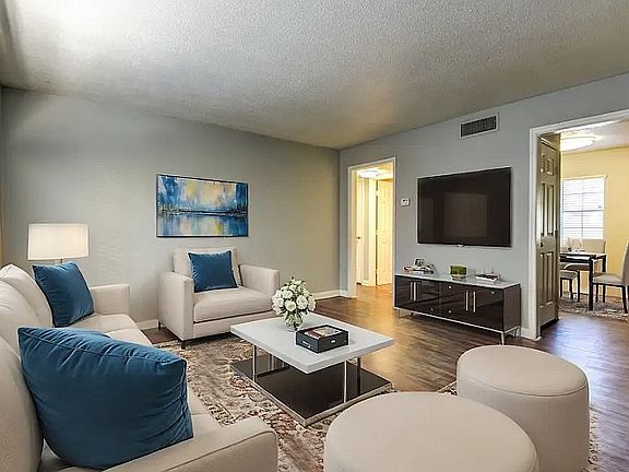 Experience comfort in this elegantly designed living room that blends style with relaxation.