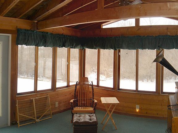 Beautiful, glassed 3 season room provides tranquil setting with lovely view.