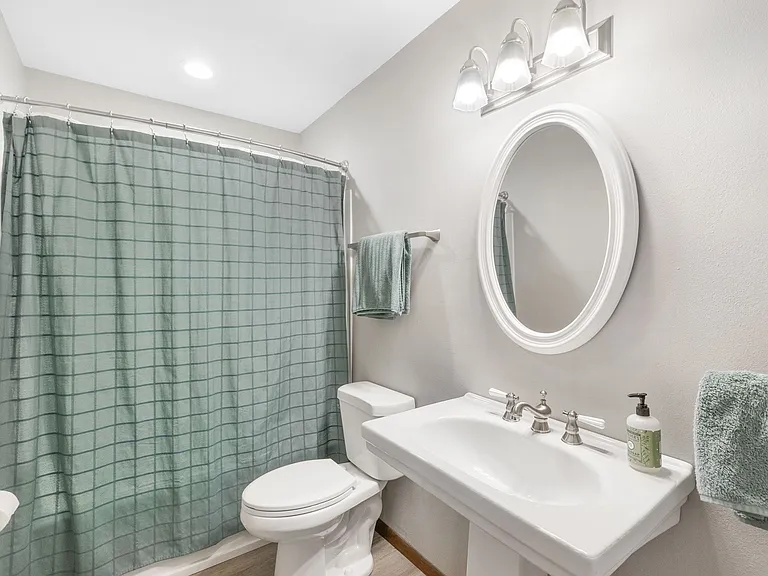 Main Floor Hall - Full Bath (tub/shower, sink, toilet)