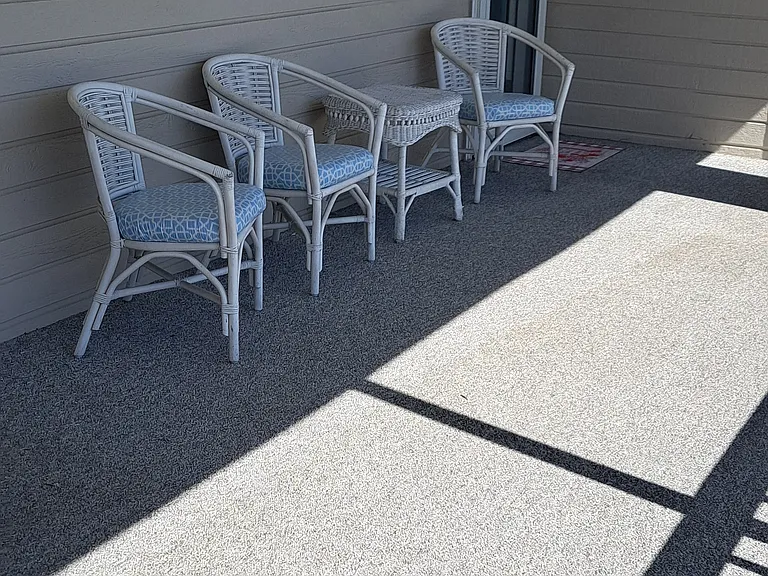 Front entrance to condo with extra seating over looking parking lot.