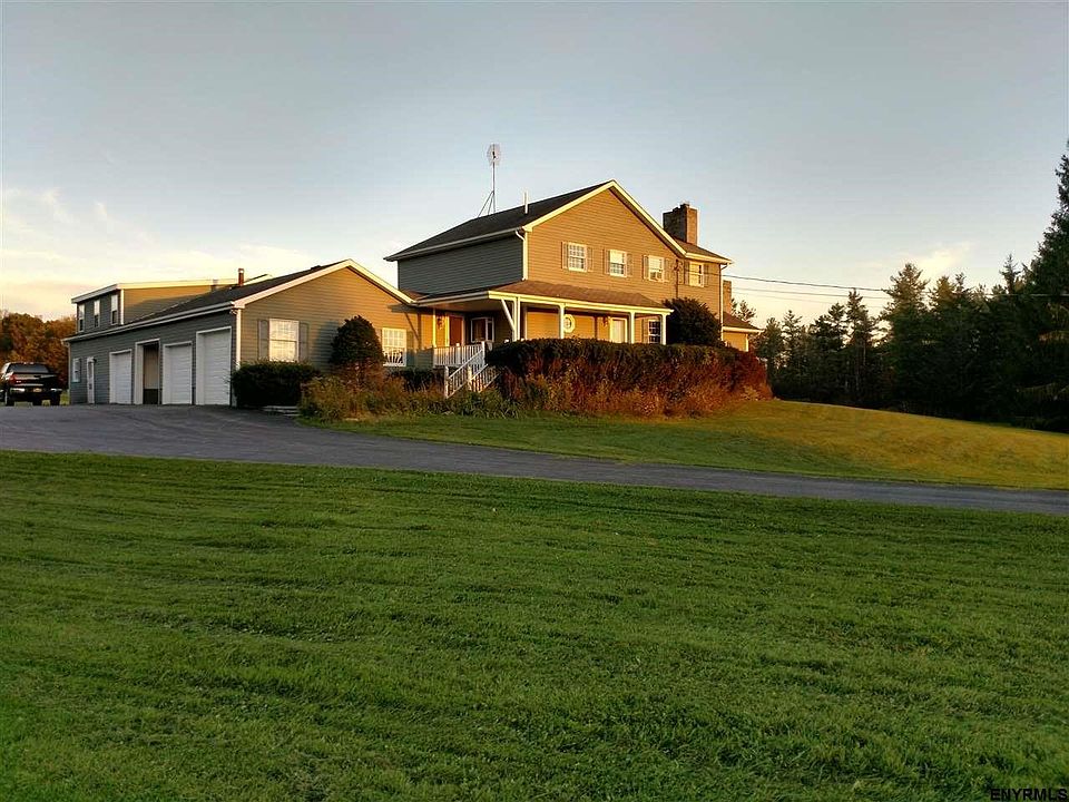 Home with 4 car garage, in-ground pool on 19 acres with 2 acre pond. Wrap around porch.