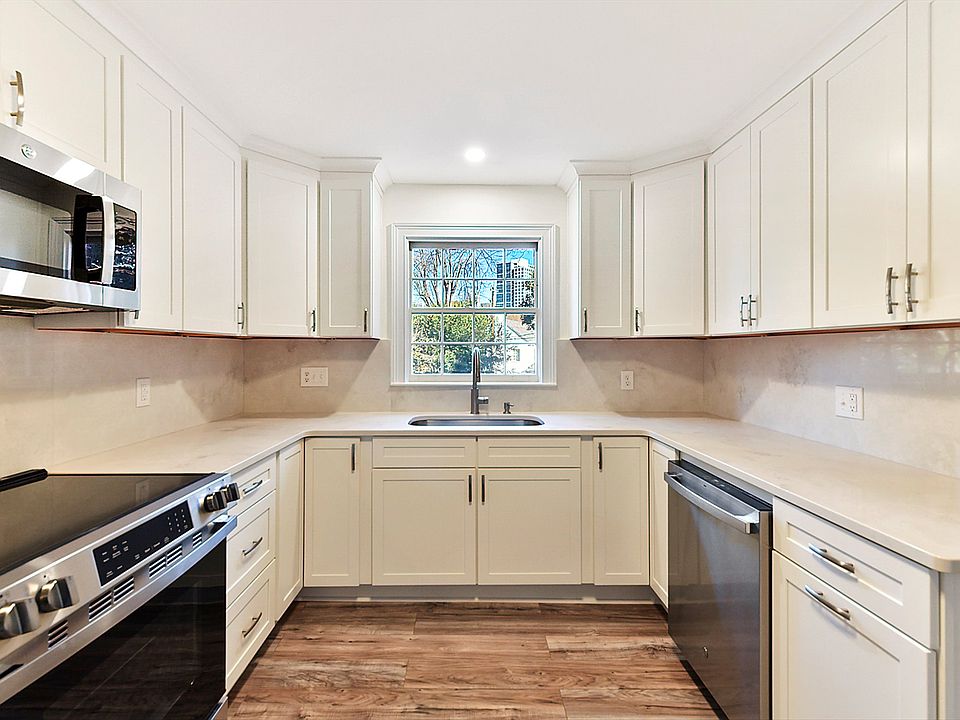 NEWLY UPDATED KITCHEN all new appliances, cabinets and flooring. And so much storage. Looking over back yard with Dilworth and Uptown views