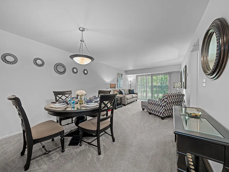 Spacious living/dining room with natural light at Westwood Village Apartments in Westland, MI
