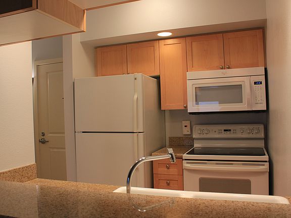 full size kitchen with granite countertops, new microwave, n