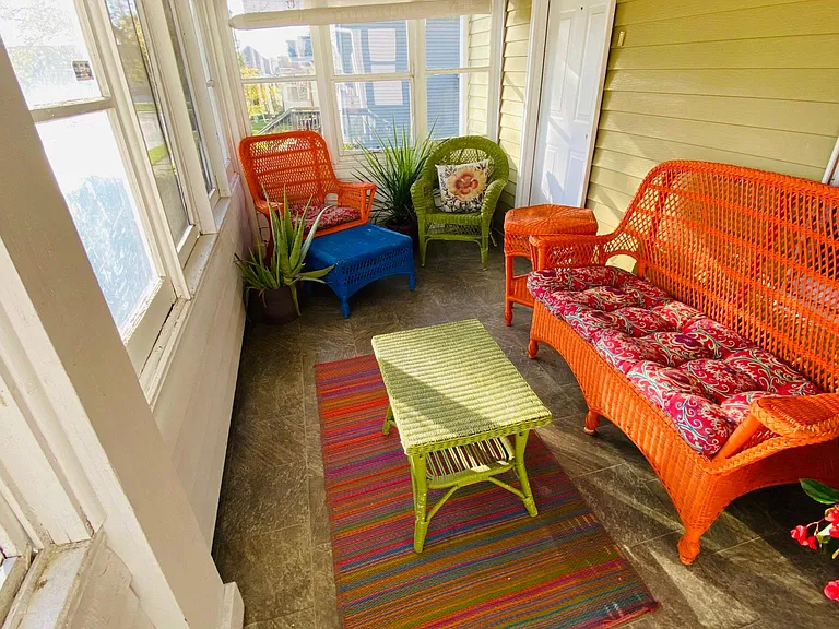Tenants love the sun porch entrance to the home. The brightly colored sun porch furnishings are listed on the lease as furnishings should tenants choose to use them.