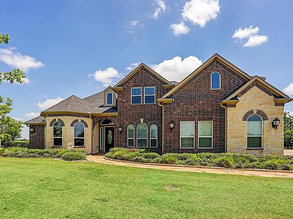 Custom built home with brick and stone features