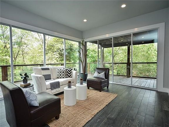 Huge sliding panels of glass that open to the surrounding deck and lush outdoors.