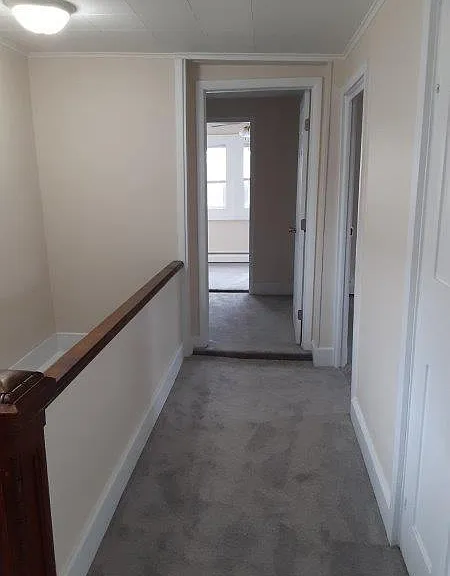 Upstairs hallway looking toward Sunroom, recreation room or possible third bedroom.