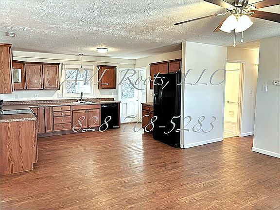 Left corner of Living Room looking towards kitchen and right side hallway