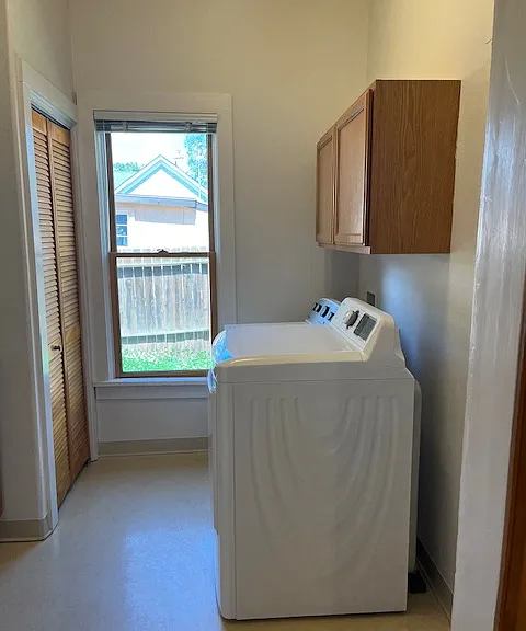 laundry room is off the kitchen with newer machines & a storage closet with more cabinets