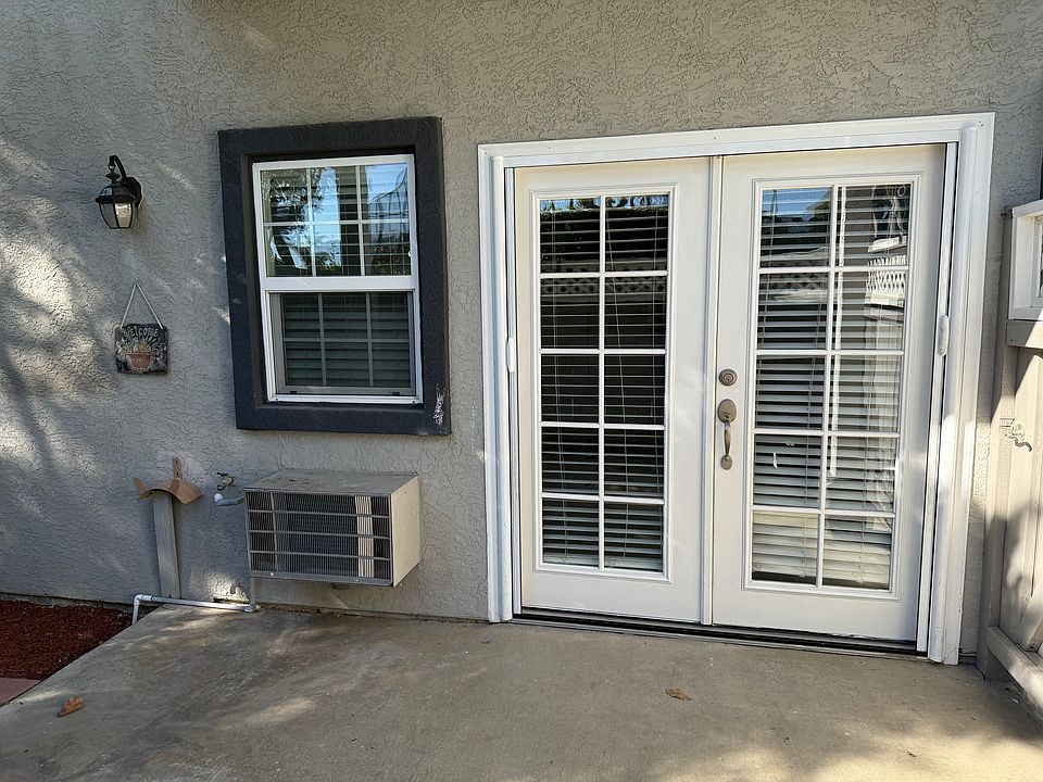 French doors with retractable mesh screen and patio. A/C