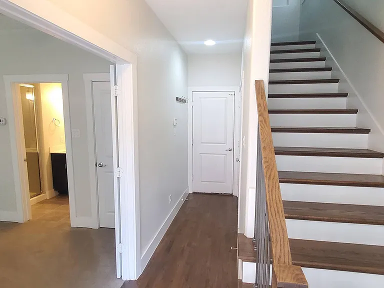 garage entrance, laundry closet, and bedroom with full bath on ground floor