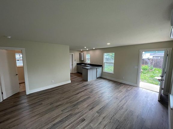 main room, diagonal towards kitchen, including closet and front door