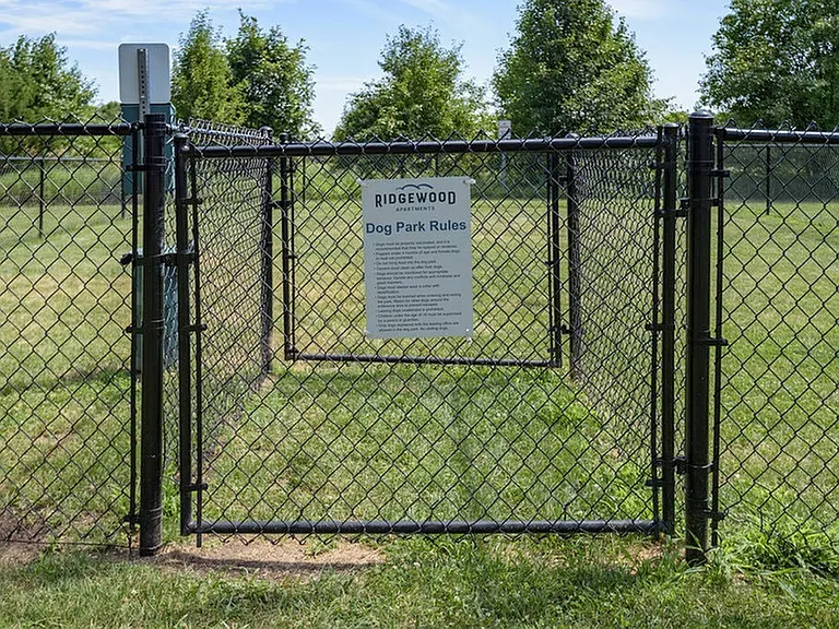 Bark park with pet waste station and bark park rules sign