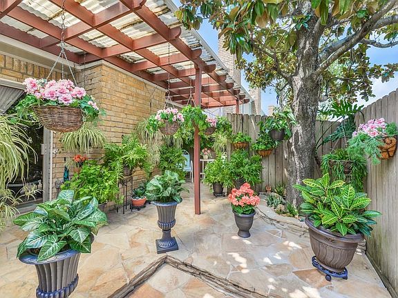 Another photo of the spacious outdoor living area with pergola and beautiful tree providing shade for those hot days!