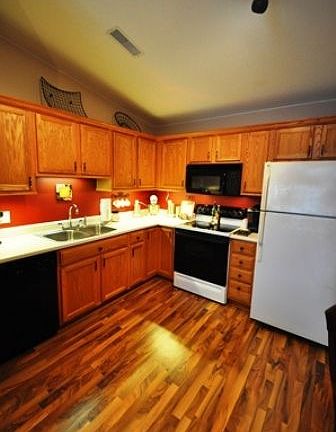 Kitchen- with wood floors, under cabinet lighting, crown molding, and all new hardware on cabinets