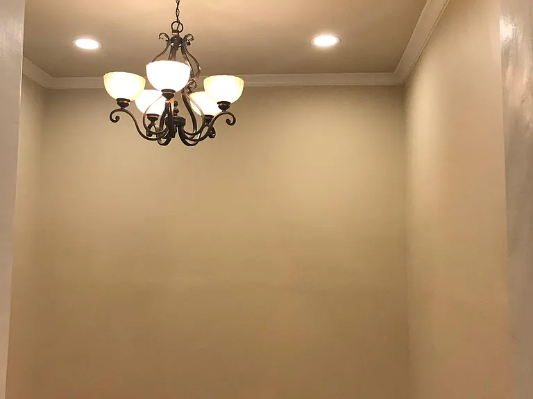 Just inside living room showing chandelier and recessed lighting