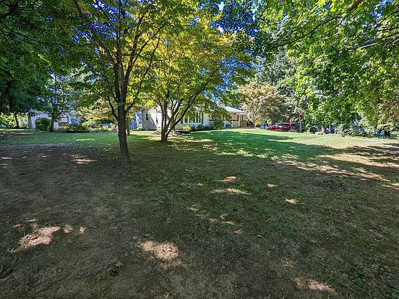 Large front yard, shaded with many mature trees