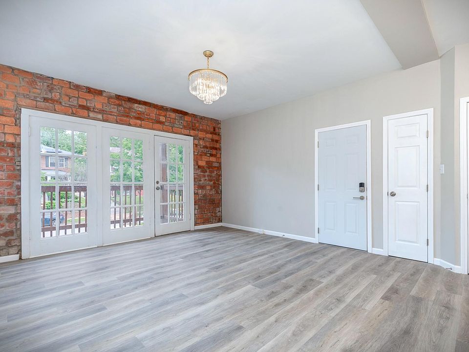 Living Room w/ original exposed brick around walk-out balcony