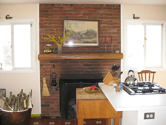 Eat-in kitchen with wood burning fireplace.