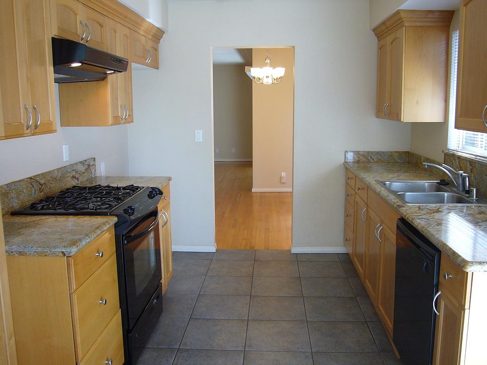 Kitchen with newer cabinets, granite countertops, tile floor