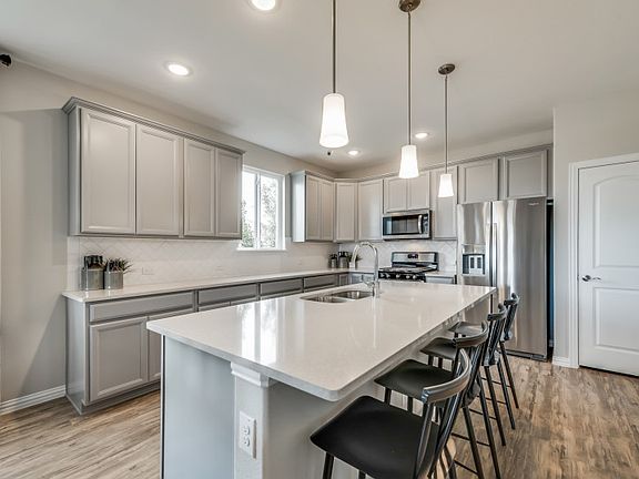 Spacious island kitchen with eat-in bartop model representation
