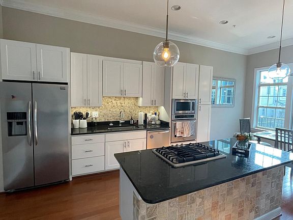 Kitchen Side 1 with large island, stainless steel appliances, gas stove top and extra storage space