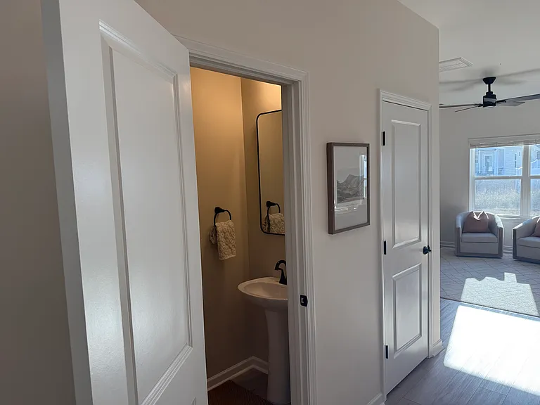 half bathroom in the entryway as you walk towards the living room