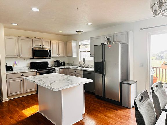 A freshly renovated kitchen featuring brand-new countertops and a fresh coat of paint