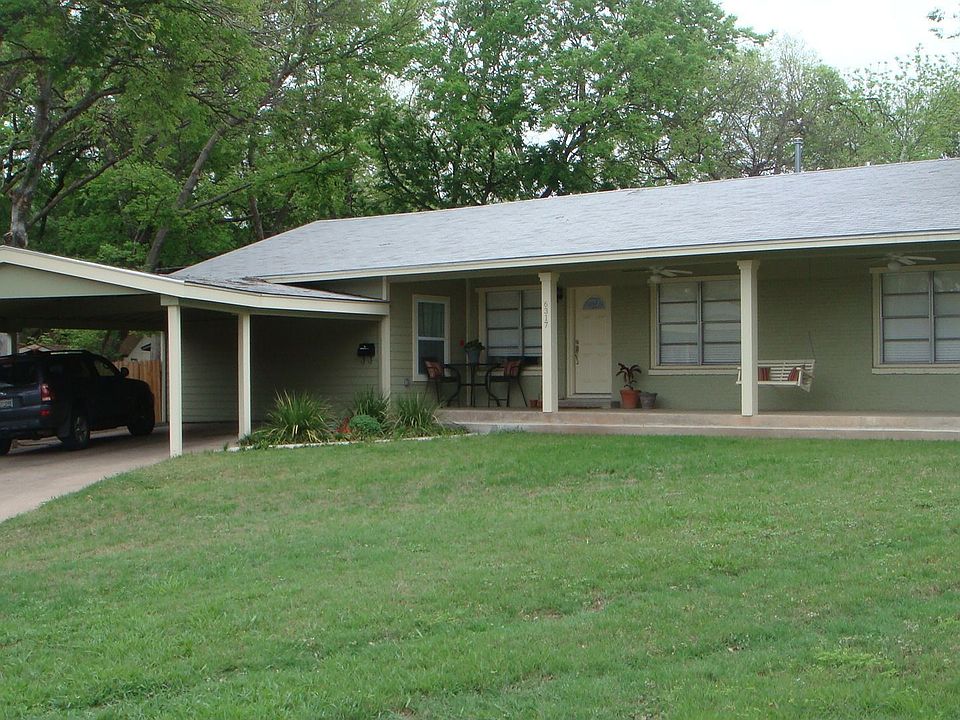 Large front porch. Carport fits 3 cars and matches architecture of house.