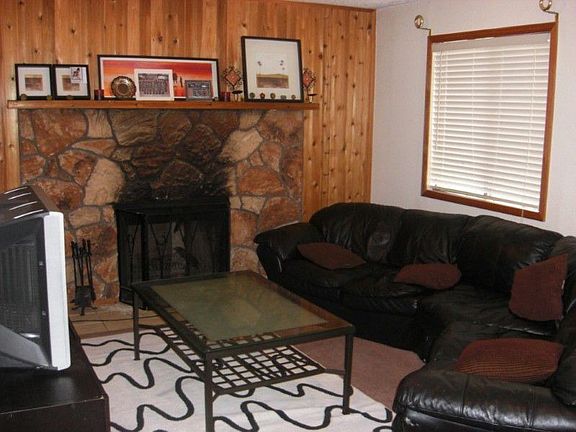 Lower level family room with wood burning fireplace.