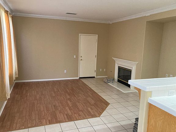 LIVING ROOM, FIREPLACE & ENTERTAINMENT CENTER & DOOR TO GARAGE