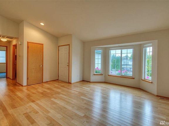 Looking into the hallway from the far side and looking out the bay windows.