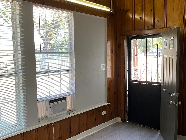 Living room and back door to fenced in yard