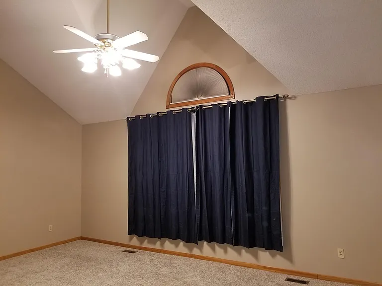 Master bedroom - Ceiling fan and large windows.