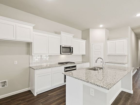 Kitchen in the Quartz home plan by Trophy Signature Homes - REPRESENTATIVE PHOTO