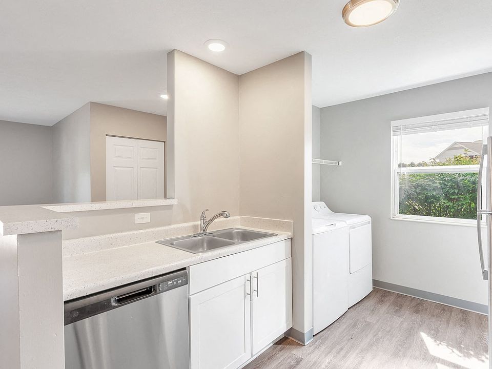 Enjoy modern kitchens featuring a large sink, dishwasher, stainless steel appliances, and bright natural lighting, professionally managed by Highlands Vista Group.