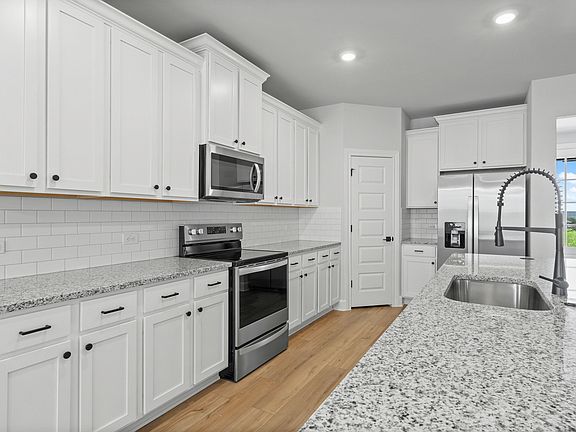 The kitchen has sprawling granite countertops.