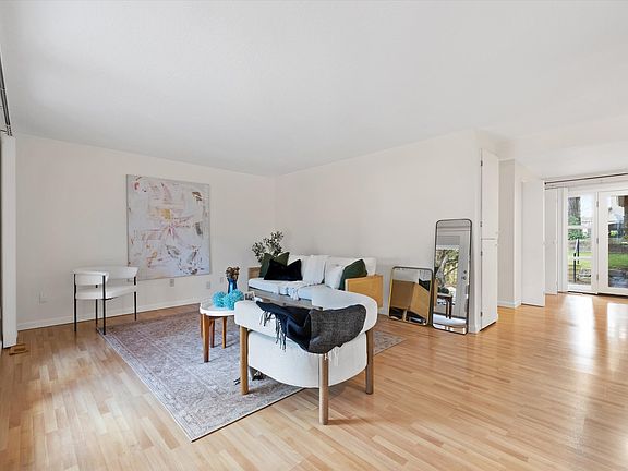 Spacious and light filled living room. *Home was staged for photos, but everything will be removed prior to showings*.
