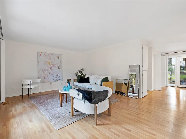 Spacious and light filled living room. *Home was staged for photos, but everything will be removed prior to showings*.