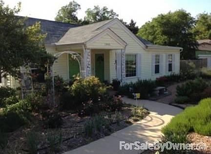 Front entrance
						:
						A curved walkway from driveway to front door is surrounded by flowers.