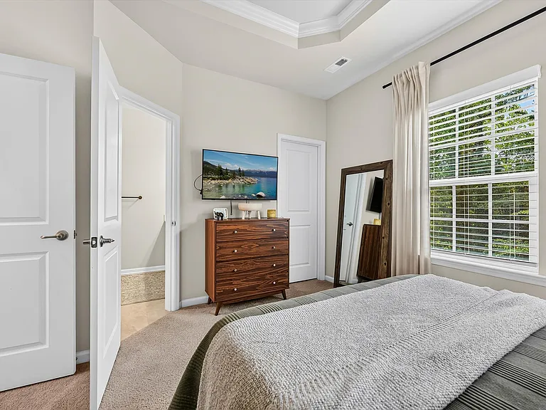 Owner's Bedroom with private trees in the backyard. Bath & closet in bedroom