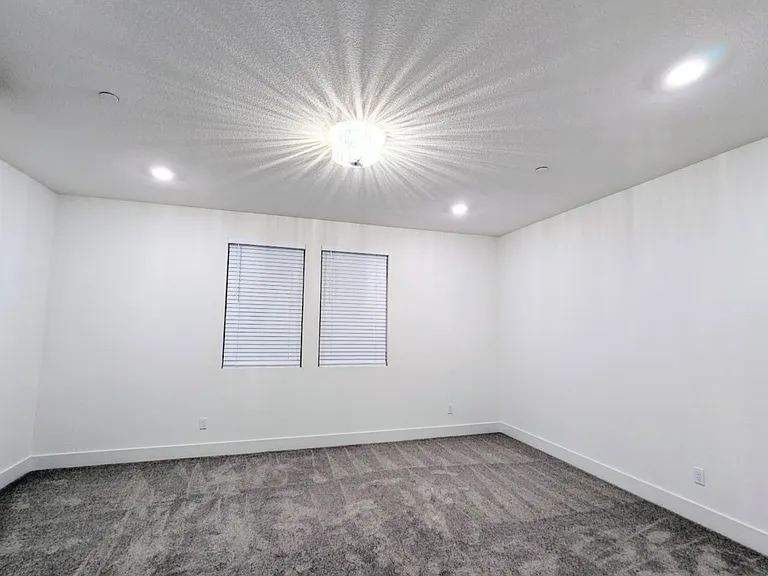 Spacious and versatile living area with upgrade light feature. This room easily accommodates a full-size sectional sofa and a dining table, offering the perfect setup to relax, work, or entertain in style. Your blank canvas for creating your ideal home.